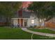 Charming home with beautiful brick accents, lush lawn, inviting walkway, and cozy front porch seating at 1751 Merriman Ave, Charlotte, NC 28203