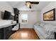 Charming home office with built-in desk, shelving, hardwood floors, and a comfortable sofa for relaxing at 1751 Merriman Ave, Charlotte, NC 28203