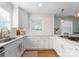 Stylish white kitchen with stainless steel appliances, quartz countertops, and ample cabinet space at 1751 Merriman Ave, Charlotte, NC 28203