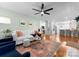 Bright living room connected to a modern kitchen, featuring hardwood floors and stylish furnishings at 1751 Merriman Ave, Charlotte, NC 28203