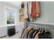 A well-organized walk-in closet with shelves, drawers, rods, and a window for natural light at 1751 Merriman Ave, Charlotte, NC 28203