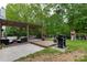 Spacious backyard featuring a patio area, grill, swing set, and lush greenery, creating a perfect space for outdoor living at 2012 Galty Ln, Charlotte, NC 28270