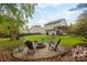 Inviting backyard featuring a fire pit, seating area, and lush green grass, creating a perfect spot for outdoor relaxation at 2012 Galty Ln, Charlotte, NC 28270