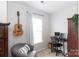 Cozy bedroom with a comfortable armchair, and a functional workspace with a desk and shelving at 2012 Galty Ln, Charlotte, NC 28270