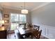 Bright dining room with natural light, a wooden table, and neutral wall paint at 2012 Galty Ln, Charlotte, NC 28270
