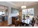 Charming dining room featuring a wooden table set, pendant lighting, and view of the backyard at 2012 Galty Ln, Charlotte, NC 28270