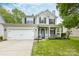 Charming two-story home with a well-manicured lawn, inviting front porch, and a two-car garage at 2012 Galty Ln, Charlotte, NC 28270