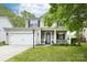 Charming two-story home featuring a well-manicured lawn, covered porch, and inviting curb appeal, perfect for a Gathering at 2012 Galty Ln, Charlotte, NC 28270