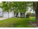 Charming two-story home with a well-manicured lawn and mature trees, creating a welcoming and picturesque exterior at 2012 Galty Ln, Charlotte, NC 28270