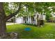Charming two-story home with a well-manicured lawn, mature trees, and a swing, creating a welcoming and picturesque exterior at 2012 Galty Ln, Charlotte, NC 28270