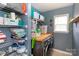 Well-organized laundry room featuring ample shelving, counter space, and a modern washer and dryer for added convenience at 2012 Galty Ln, Charlotte, NC 28270