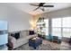 Bright living room with a comfortable couch, ottoman with coffee, indoor plants, and large windows with natural light at 2012 Galty Ln, Charlotte, NC 28270
