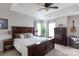 Spacious main bedroom with a king bed, large windows, tray ceiling, ceiling fan, and stylish decor at 2012 Galty Ln, Charlotte, NC 28270