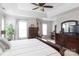 Bright, spacious main bedroom with large windows, a king-sized bed and a desk area at 2012 Galty Ln, Charlotte, NC 28270
