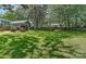 View of the large, shady backyard with mature trees, a well-maintained lawn, and a privacy fence at 218 Kimrod Ln, Charlotte, NC 28270
