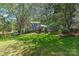 Beautiful backyard showcasing lush greenery, mature trees, and the home's exterior at 218 Kimrod Ln, Charlotte, NC 28270