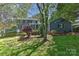 Spacious backyard featuring a well-maintained lawn, privacy landscaping, and the home's exterior at 218 Kimrod Ln, Charlotte, NC 28270