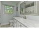 Bathroom featuring a white vanity with marble countertop and a large mirror at 218 Kimrod Ln, Charlotte, NC 28270