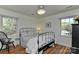 Bedroom with wood flooring, windows, and an iron bed frame with white linens at 218 Kimrod Ln, Charlotte, NC 28270