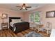 Comfortable bedroom with wood floors, a ceiling fan, and stylish decor at 218 Kimrod Ln, Charlotte, NC 28270