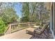 Relax on this backyard deck with lounge chairs, overlooking the lush greenery and mature trees at 218 Kimrod Ln, Charlotte, NC 28270