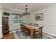 Bright dining area featuring a wooden table, ample seating, and a sunlit window at 218 Kimrod Ln, Charlotte, NC 28270