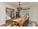 Spacious dining area featuring a large wooden table with seating, a glass cabinet and staircase at 218 Kimrod Ln, Charlotte, NC 28270