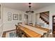 Open dining room area with a large wooden table, seating for six, and decorative lighting at 218 Kimrod Ln, Charlotte, NC 28270