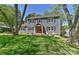 Classic home exterior with a covered porch, wooden trim and a beautifully manicured front lawn at 218 Kimrod Ln, Charlotte, NC 28270