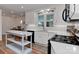 Modern kitchen with white cabinets, sleek appliances, granite countertops, and an adjacent dining area at 218 Kimrod Ln, Charlotte, NC 28270