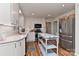 Bright kitchen with white cabinets, stainless steel appliances, wood floors, and stylish backsplash at 218 Kimrod Ln, Charlotte, NC 28270