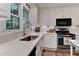Well-lit kitchen features white cabinets, granite countertops, stainless steel appliances, and decorative accents at 218 Kimrod Ln, Charlotte, NC 28270