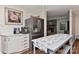 Bright kitchen featuring a stainless steel refrigerator, white cabinets, and a kitchen island with floral decor at 218 Kimrod Ln, Charlotte, NC 28270