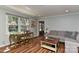 Cozy living room featuring hardwood floors, neutral paint, a plush couch, and natural light through the window at 218 Kimrod Ln, Charlotte, NC 28270
