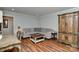 Comfortable living room showcasing an L-shaped couch, chess set, and decorative cabinet, all on hardwood floors at 218 Kimrod Ln, Charlotte, NC 28270