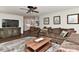 Comfortable living room featuring hardwood floors, a ceiling fan, and access to the bright kitchen at 218 Kimrod Ln, Charlotte, NC 28270