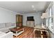 Bright living room featuring wood floors, neutral walls, comfortable seating, and decorative wood furniture at 218 Kimrod Ln, Charlotte, NC 28270