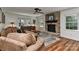 Inviting living room with a stone fireplace, ceiling fan, and plush seating area at 218 Kimrod Ln, Charlotte, NC 28270
