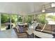 Bright sunroom with a ceiling fan and comfortable seating with views of the outdoors at 218 Kimrod Ln, Charlotte, NC 28270