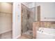 The bathroom features a glass-enclosed shower with decorative tile and a separate soaking tub at 2415 Tory Oak Pl, Matthews, NC 28105