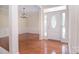 Welcoming foyer featuring hardwood floors, decorative molding and a front door with glass panel at 2415 Tory Oak Pl, Matthews, NC 28105
