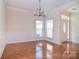 Bright foyer showcases hardwood floors and modern chandelier at 2415 Tory Oak Pl, Matthews, NC 28105