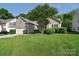Charming home with lush landscaping and a well-manicured front lawn on a sunny day at 2415 Tory Oak Pl, Matthews, NC 28105