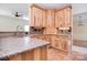 Bright kitchen with wood cabinets, granite counters and stainless steel faucet at 2415 Tory Oak Pl, Matthews, NC 28105