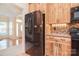 Kitchen showcases stainless steel refrigerator and modern wooden cabinetry at 2415 Tory Oak Pl, Matthews, NC 28105