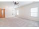 Bright and airy living room with neutral carpeting and natural light pouring in through the windows at 2415 Tory Oak Pl, Matthews, NC 28105