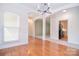 Living room features hardwood floors, arched entryways and natural light at 2415 Tory Oak Pl, Matthews, NC 28105