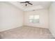 Large, well-lit main bedroom with neutral carpet, ceiling fan, and tray ceiling at 2415 Tory Oak Pl, Matthews, NC 28105