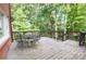 Enjoy nature on this back deck with outdoor furniture surrounded by mature trees, providing a serene, private retreat at 2540 Heritage Cir, Statesville, NC 28625
