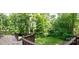 Back deck has steps leading down into the yard and lots of green space with mature trees at 2540 Heritage Cir, Statesville, NC 28625